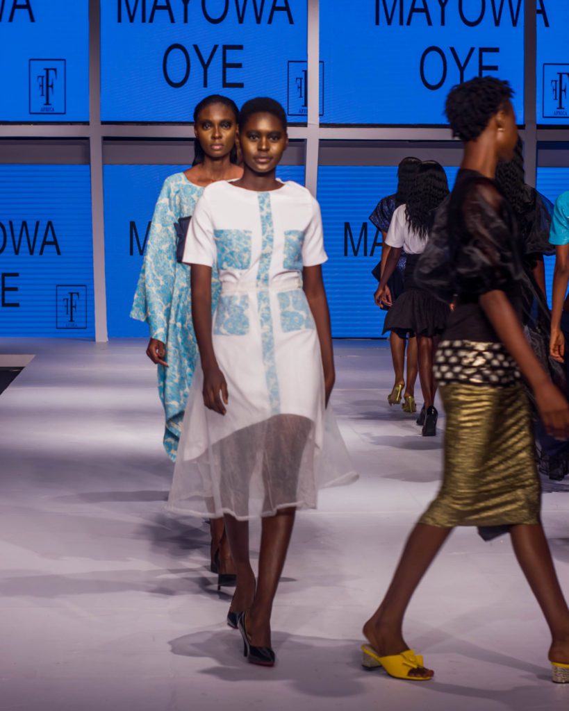A cross section of models wearing Mayowa Oye design pieces on the runway