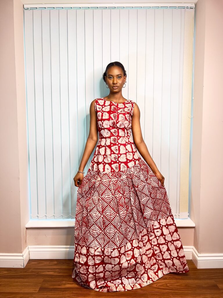 Long, flowy sleeveless dress in a mixture of red and white colors