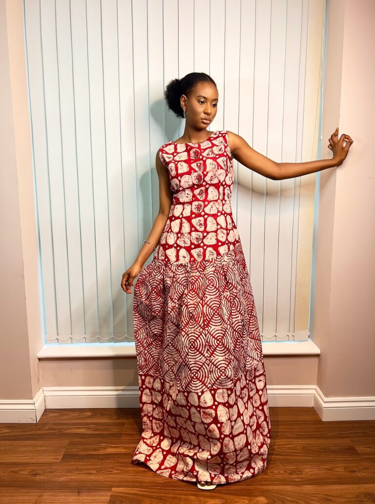 Long, flowy sleeveless dress in a mixture of red and white colors