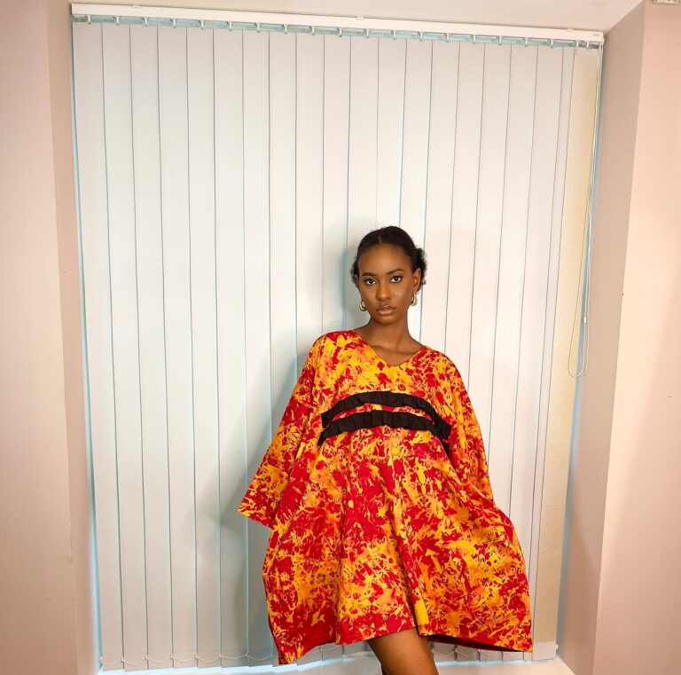 Orange kaftan with black ruffle details