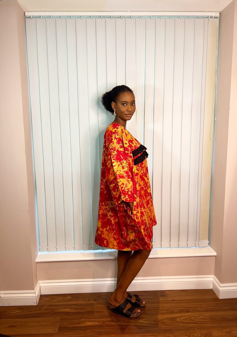 Orange kaftan with black ruffle details