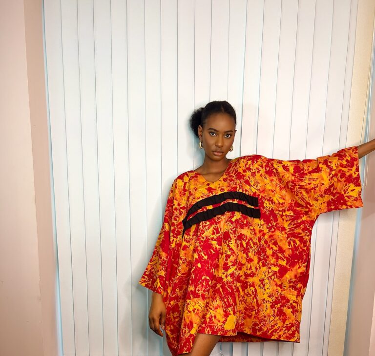 Orange kaftan with black ruffle details