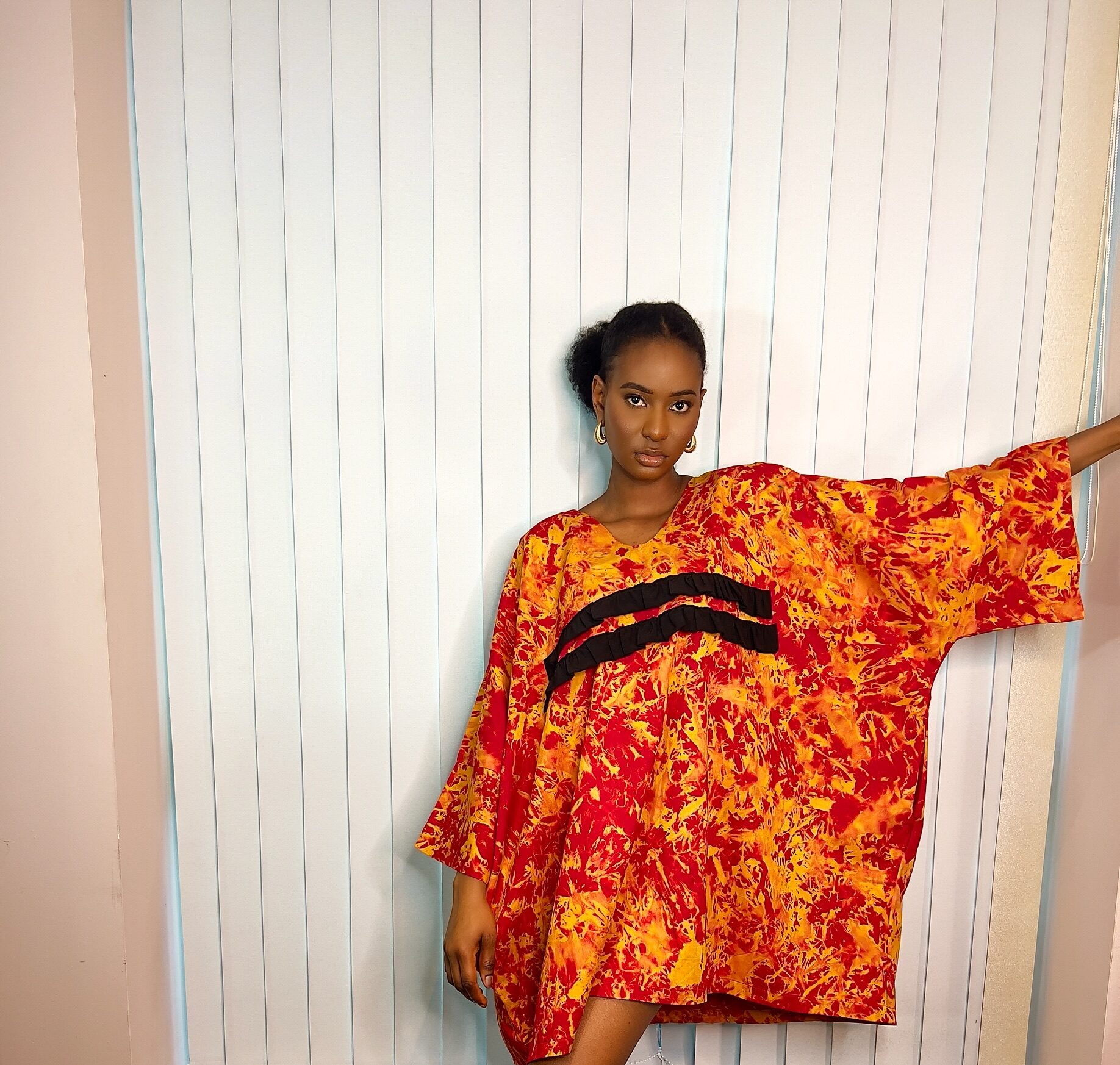 Orange kaftan with black ruffle details