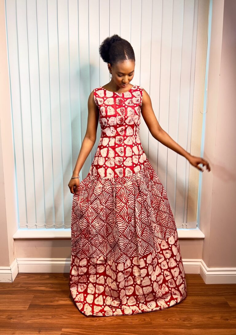 Long, flowy sleeveless dress in a mixture of red and white colors