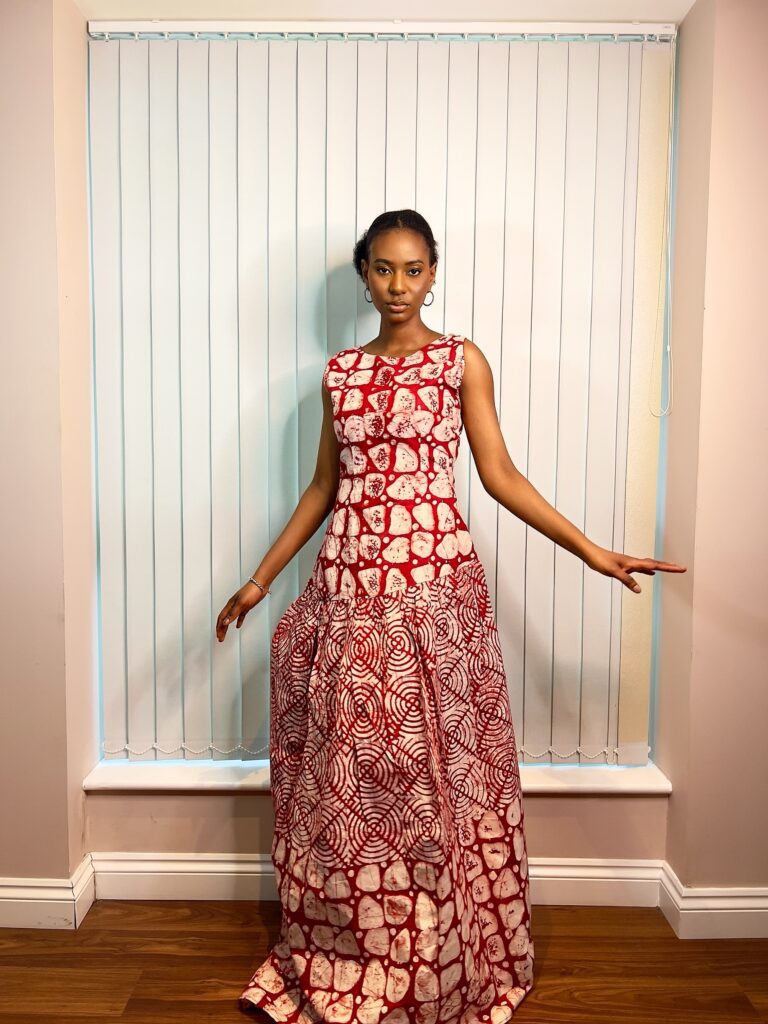 Long, flowy sleeveless dress in a mixture of red and white colors